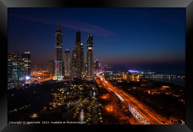 Dubai dusk illuminated view Sheikh Zayed city skyscrapers  Framed Print by Spotmatik 