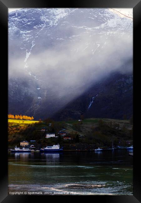 Sunlight beaming though light mist Norwegian glacial fjord  Framed Print by Spotmatik 