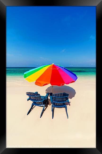 Parasol  beach chairs on white tropical sandy shoreline Framed Print by Spotmatik 