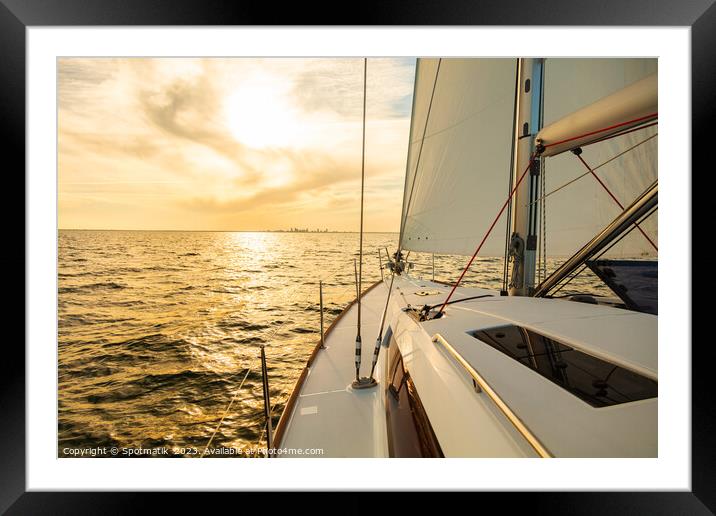 Sailing private yacht towards city skyline at sunrise Framed Mounted Print by Spotmatik 