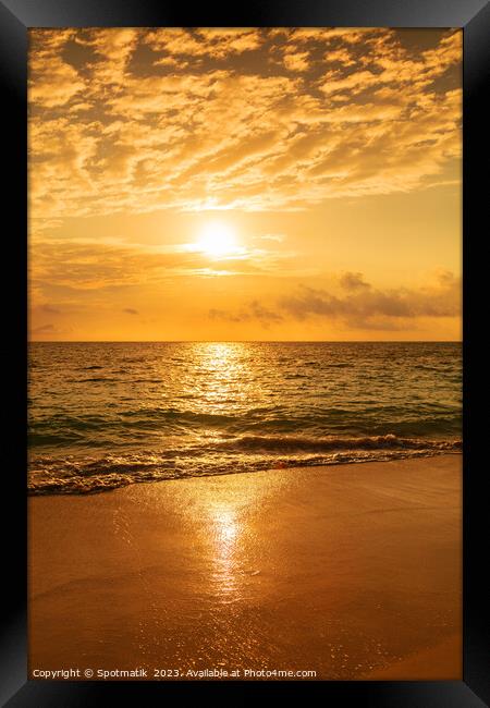 Sunset reflecting on ocean at tourist destination Bahamas Framed Print by Spotmatik 