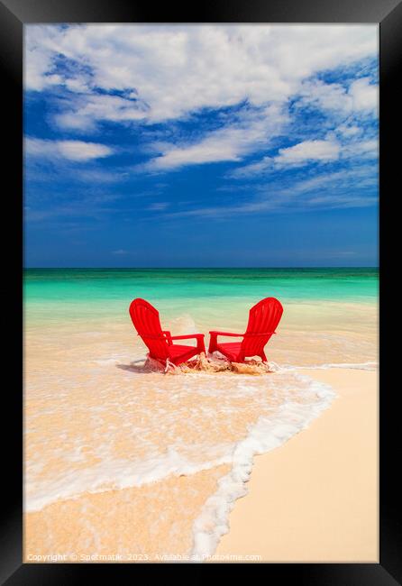 Red chairs on shoreline of sandy beach Bahamas Framed Print by Spotmatik 