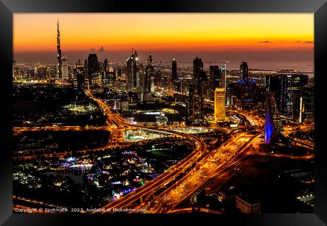 Aerial view of illuminated Dubai at sunset UAE  Framed Print by Spotmatik 