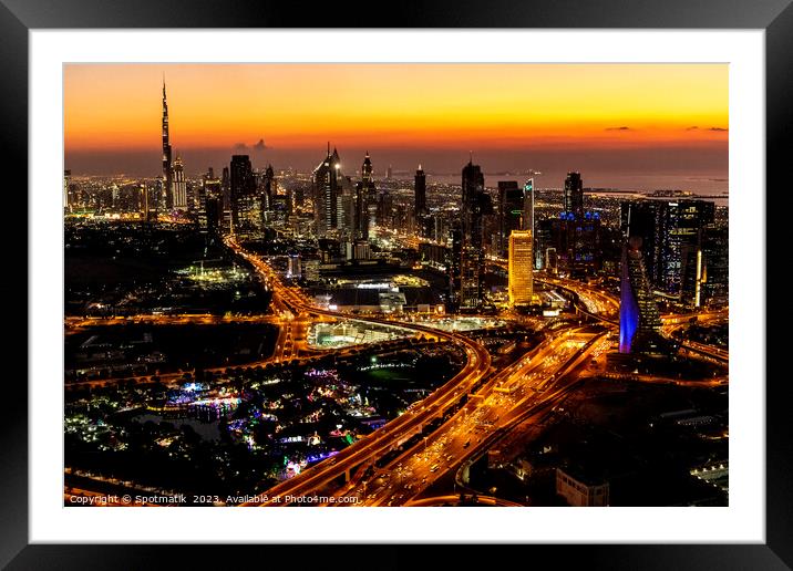 Aerial view of illuminated Dubai at sunset UAE  Framed Mounted Print by Spotmatik 
