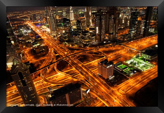 Aerial Dubai view at night Sheikh Zayed Road  Framed Print by Spotmatik 