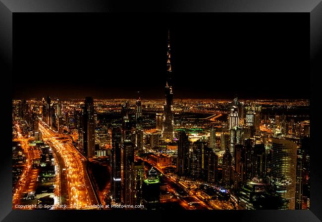 Aerial Dubai illuminated night view of Burj Khalifa  Framed Print by Spotmatik 