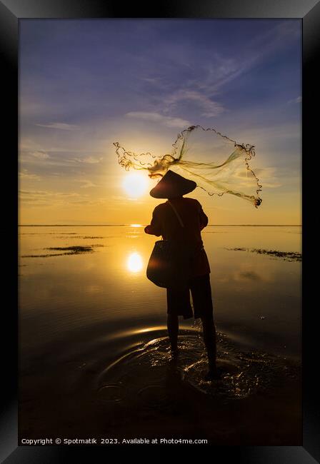 Balinese fisherman casting net Flores sea sunrise Framed Print by Spotmatik 