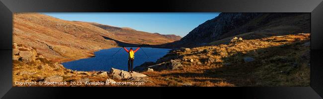 Panoramic female backpacker enjoying scenic lake view Snowdonia Framed Print by Spotmatik 