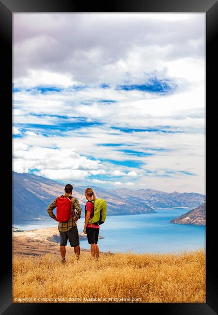 New Zealand Male female hikers trekking The Remarkables Framed Print by Spotmatik 