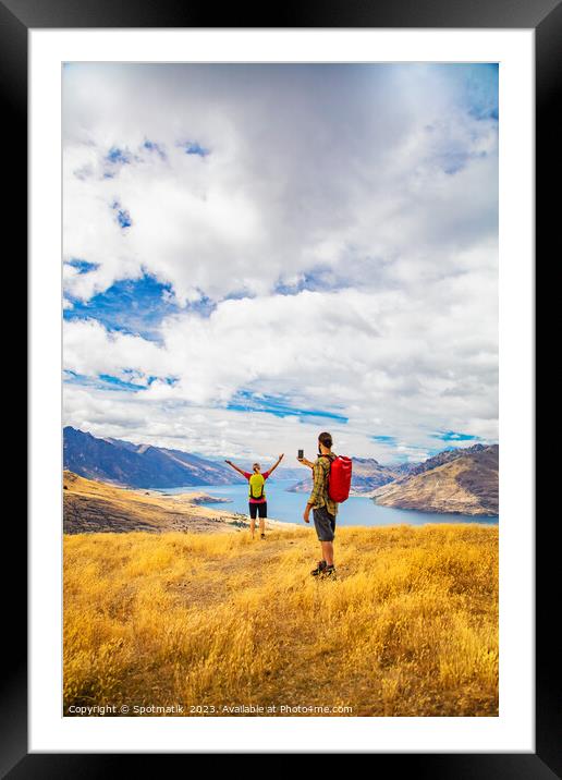 Young male taking picture of female friend Queenstown Framed Mounted Print by Spotmatik 
