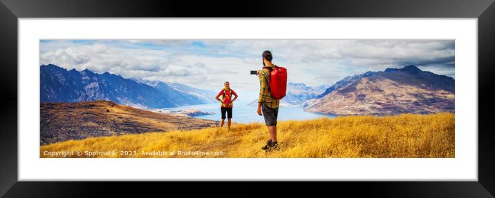 Panorama of male taking smartphone travel photos of girlfriend Framed Mounted Print by Spotmatik 