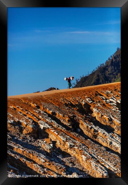 Indonesian male worker carrying sulphur blocks volcano Rim  Framed Print by Spotmatik 