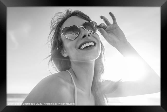 Caucasian girl wearing heart shaped sunglasses on beach Framed Print by Spotmatik 