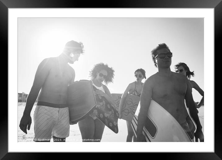 Group of friends with bodyboards on beach vacation Framed Mounted Print by Spotmatik 