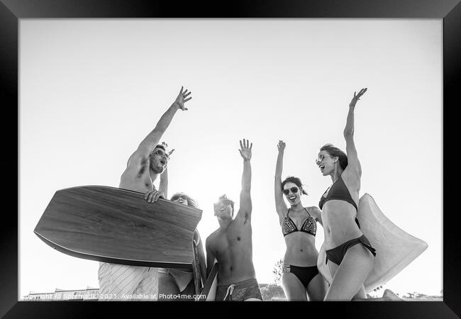 Friends in swimwear with bodyboards celebrating Summer vacation Framed Print by Spotmatik 