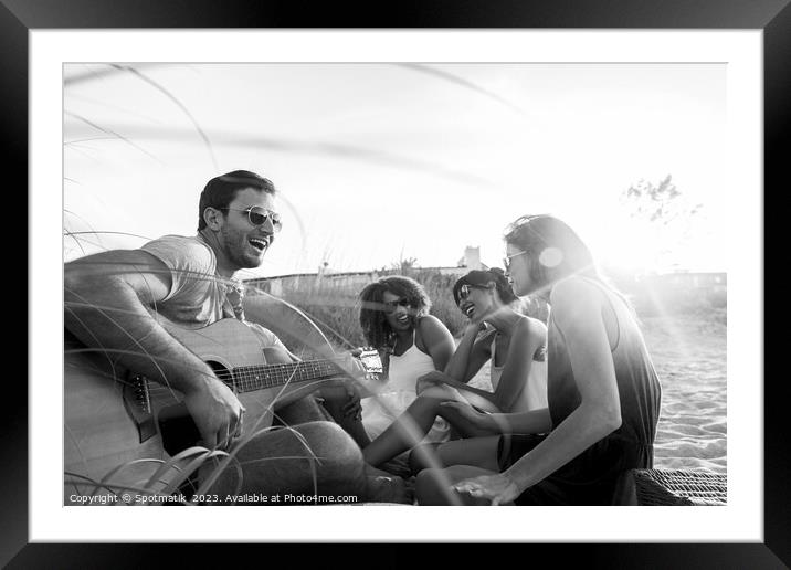 Young friends enjoying guitar music on beach vacation Framed Mounted Print by Spotmatik 