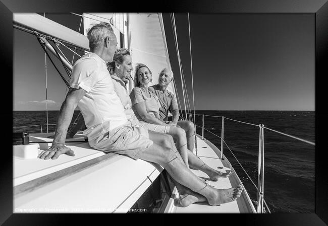 Group of seniors enjoying healthy retirement on yacht Framed Print by Spotmatik 