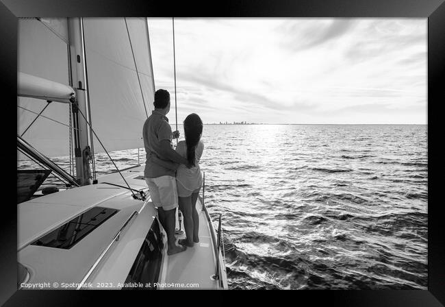 Hispanic couple travelling on luxury yacht at sunset Framed Print by Spotmatik 