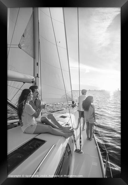 Hispanic family enjoying vacation on yacht at sunset Framed Print by Spotmatik 