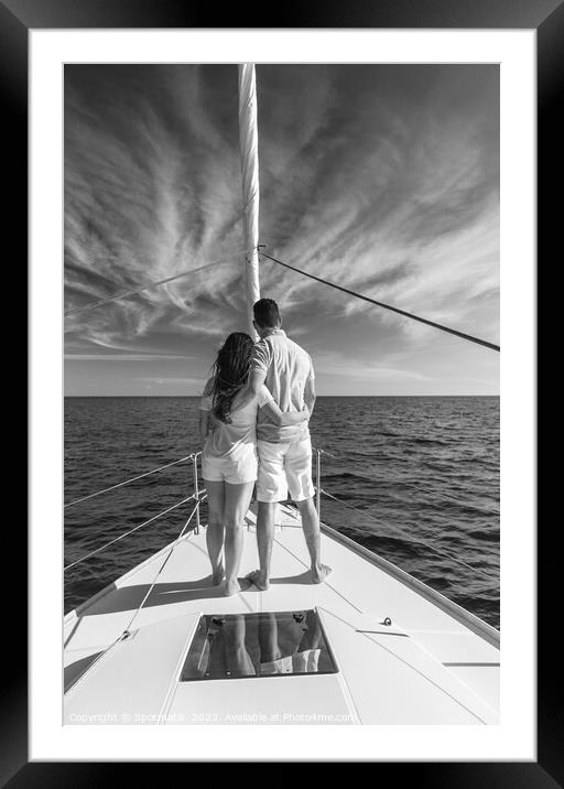 Loving young Latino couple standing on luxury yacht Framed Mounted Print by Spotmatik 