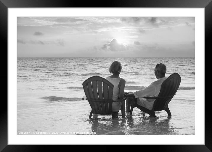 Retired couple enjoying sunset view over ocean Bahamas Framed Mounted Print by Spotmatik 