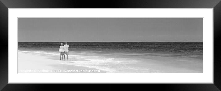 Panoramic view of mature couple walking on beach Framed Mounted Print by Spotmatik 