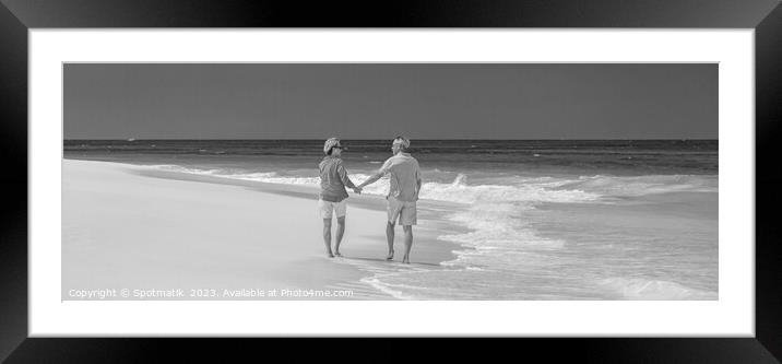 Panoramic beach view with retired couple holding hands Framed Mounted Print by Spotmatik 
