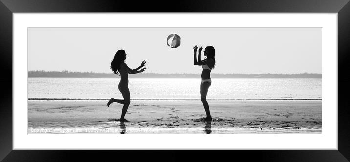Panoramic silhouette friends with beach ball at sunset Framed Mounted Print by Spotmatik 