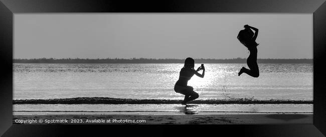 Panoramic ocean sunrise with girl jumping for photo Framed Print by Spotmatik 