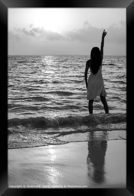 Young Asian woman enjoying ocean sunset on vacation Framed Print by Spotmatik 