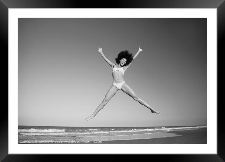 Happy African American girl jumping by the ocean Framed Mounted Print by Spotmatik 