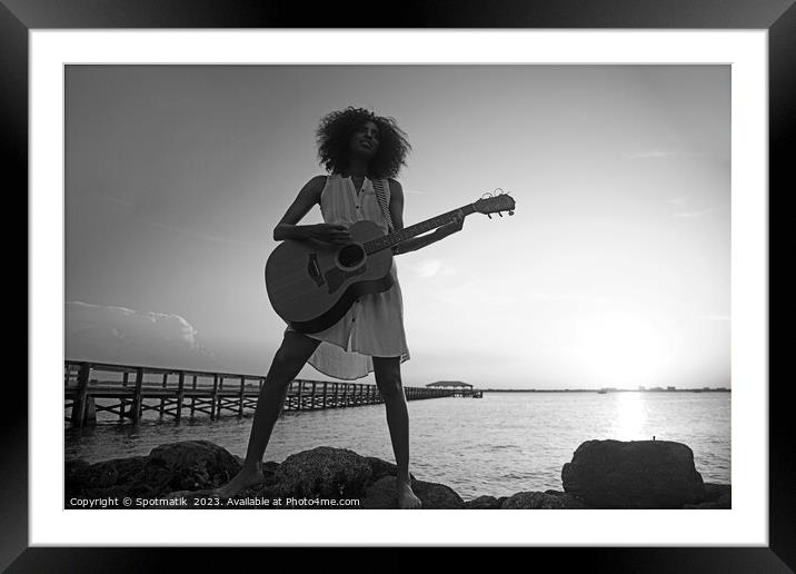 Young African American woman playing guitar at sunrise Framed Mounted Print by Spotmatik 