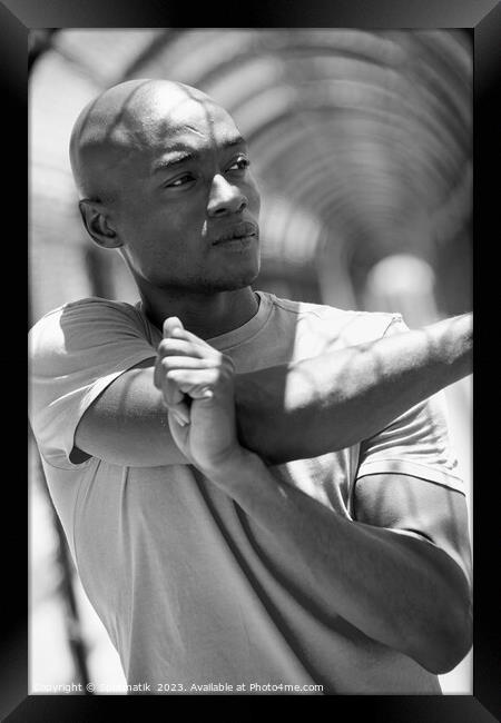 African American man stretching before outdoor sports activity Framed Print by Spotmatik 