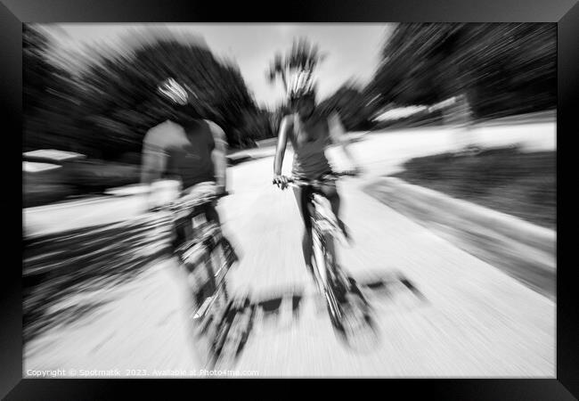 Afro American cyclists riding bikes in motion blur Framed Print by Spotmatik 