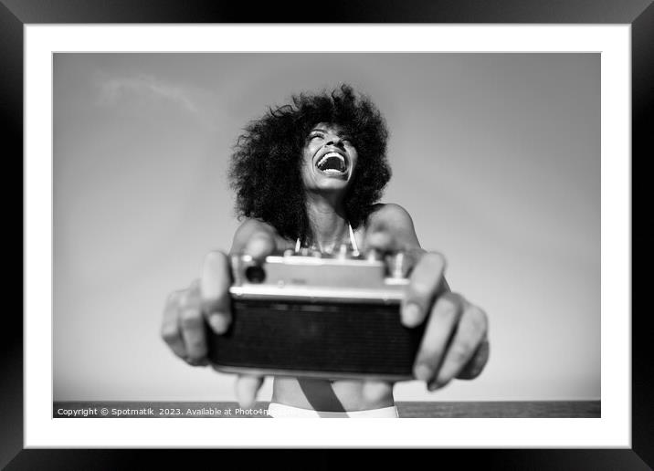 Laughing Afro American girl taking selfie on beach Framed Mounted Print by Spotmatik 