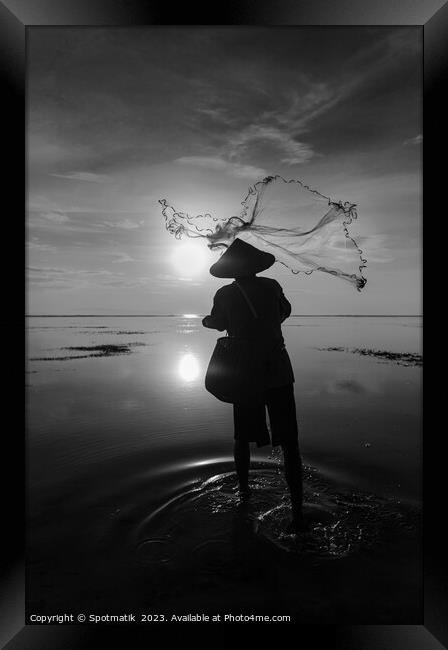 Balinese fisherman casting net Flores sea at sunrise Framed Print by Spotmatik 