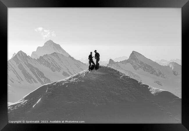 Aerial Switzerland two climbers on snow covered Peak Framed Print by Spotmatik 