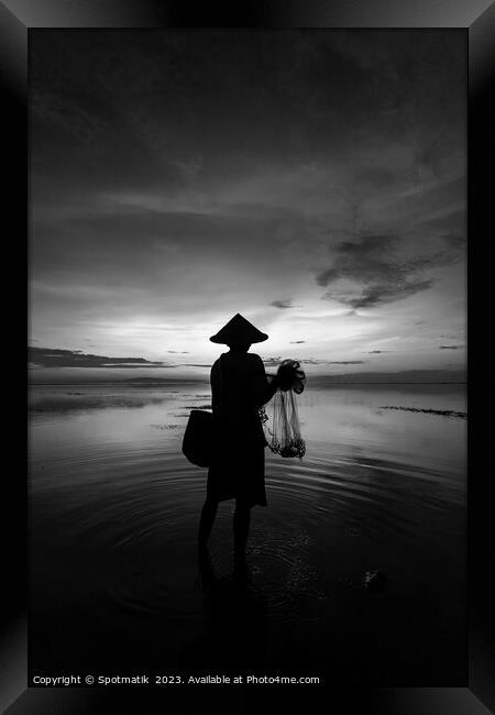 Balinese male fishing at sunrise Flores sea coastline  Framed Print by Spotmatik 