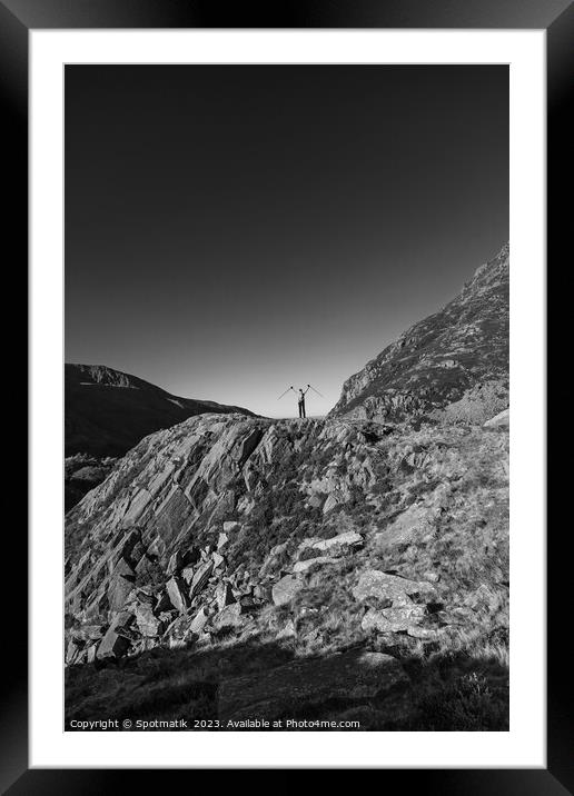 Happy female backpacker on rugged mountain peak Snowdonia Framed Mounted Print by Spotmatik 