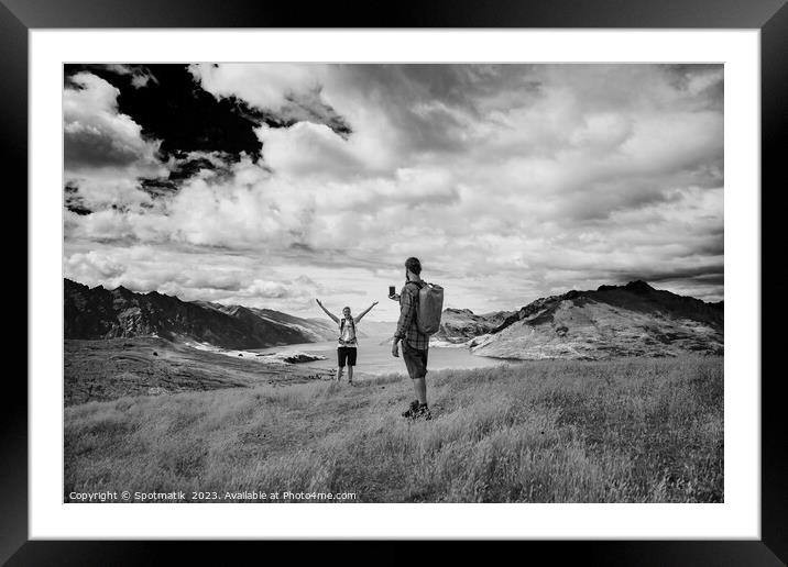 Successful young couple taking smartphone picture Lake Wakatipu  Framed Mounted Print by Spotmatik 