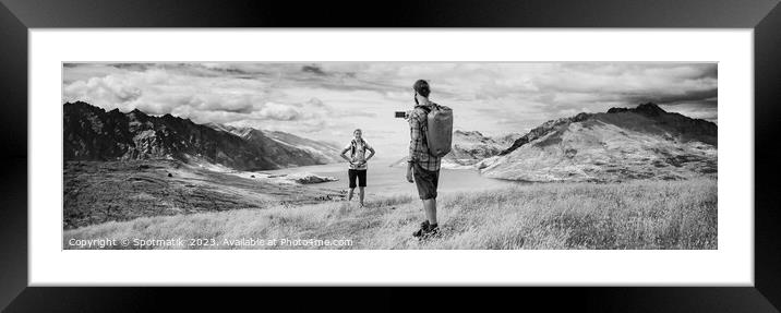 Panorama of male taking smartphone travel pictures of girlfriend Framed Mounted Print by Spotmatik 