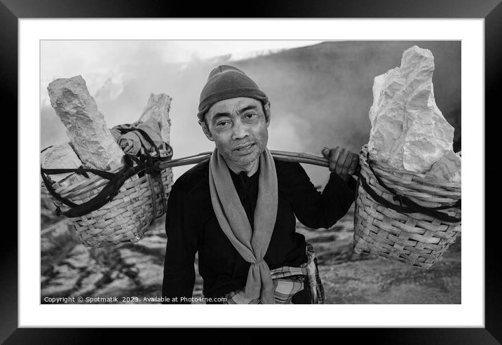 Indonesian worker manually carrying sulphur blocks from volcano  Framed Mounted Print by Spotmatik 