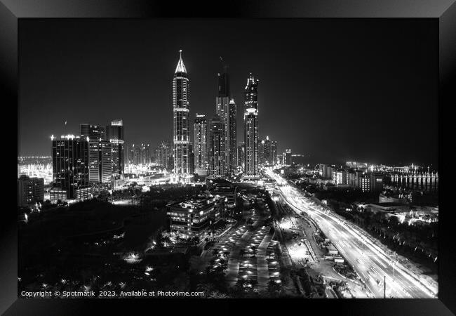 Night Dubai illuminated view of modern city Skyscrapers Framed Print by Spotmatik 