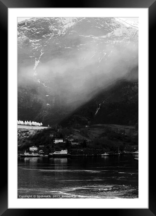 Sunlight beaming through light mist Norwegian glacial fjord  Framed Mounted Print by Spotmatik 