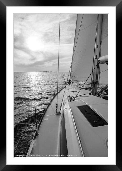 Luxury yacht sailing towards distant horizon at sunset Framed Mounted Print by Spotmatik 