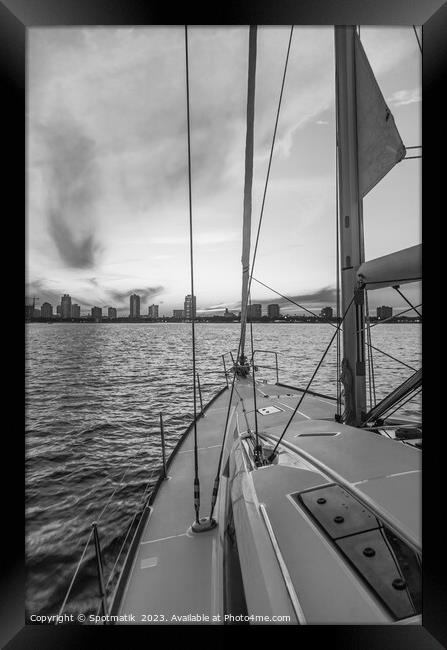 Sailing luxury yacht at sunset with cityscape view Framed Print by Spotmatik 