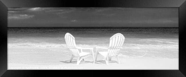 Panoramic white chairs on beach beside ocean Framed Print by Spotmatik 