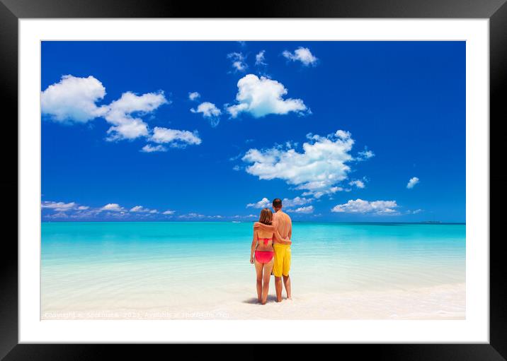 Happy Caucasian couple together on beach holiday Caribbean Framed Mounted Print by Spotmatik 