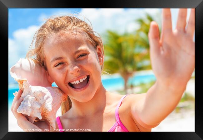 Portrait of beautiful girl with seashell on beach Framed Print by Spotmatik 