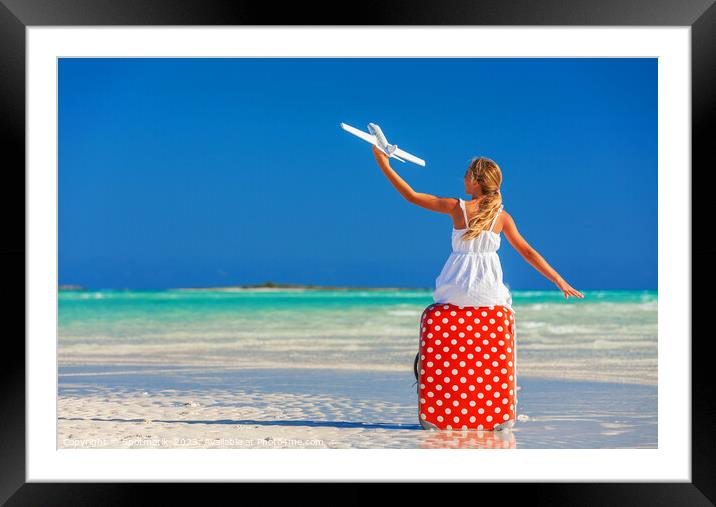 Girl sitting on red travel luggage on beach plane Framed Mounted Print by Spotmatik 